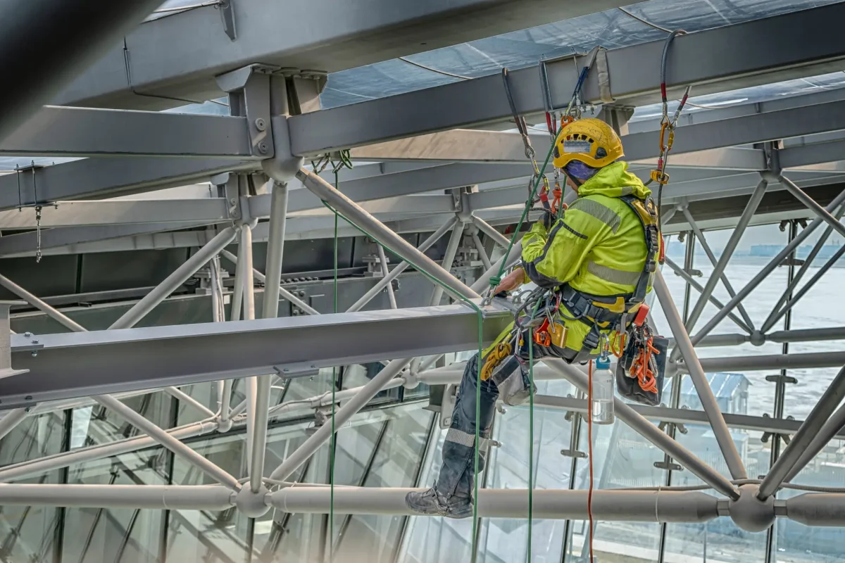 Rope access technicians assemble metal structure